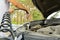 Adding windshield washer fluid at gasolin station by driver. Close-up of adding windshield washer fluid on a car. car