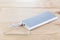 An additional stand-alone power bank for charging mobile devices. External battery on a wooden background. White charger for