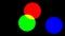 Additive color mixing concept from red, green and blue circles over black background