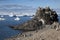 Adelie penguins on the beach with zodiac in background