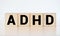 ADHD abbreviation on wooden blocks. ADHD is Attention deficit hyperactivity disorder. Close up. Vignette