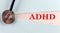 ADHD word made on torn paper, medical concept background