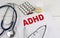 ADHD word on paper with stethoscope and pills