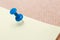 Adhesive note and blue pushpin