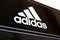 Adidas sports shop sign with logo at Ashford Outlet Center, Kent, England, UK.