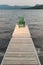 Adirondack chair on a wooden dock.