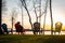 Adirondack chairs next to lake at sunset on a clear day