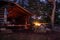 Adirondack Lean to Bushcraft camp shelter with fire at night in the mountains.