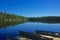 Adirondack Park, New York, USA: Canoes tied to a wooden dock on Sagamore Lake