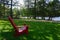 Adirondack Park, New York, USA: No one sitting in a red wood Adirondack chair