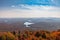 Adirondacks mountain range view from Mt Arab fire tower with brilliant fall foliage on a sunny afternoon