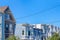 Adjacent residential buildings with victorian style against the clear sky in San Francisco, CA