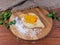 Adjarian khachapuri on wooden floured cutting board on rustic table