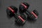 Adjustable weight dumbbell in plastic polymer material on black rubber floor