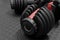 Adjustable weight dumbbell in plastic polymer material on black rubber floor