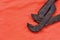 Adjustable wrench against the background of an orange signal worker shirt. Still life associated with repair, railway or plumbing
