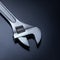 Adjustable wrench on a gray background