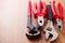 Adjustable wrench, pliers, claw hammer and pliers on the wooden background