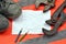 Adjustable wrenches with old boots and a sheet of paper with two pencils. Still life associated with repair, railway or plumbing