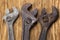 Adjustable wrenches on a wooden background