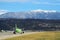 Adler, Russia. Travel. Airfield view. Sochi International airport. Green grass between runways and beautiful mountains on