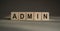 ADMIN word written on wooden blocks on a brown background