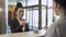 Administrator gives a key from a room to a businesswoman in a hotel