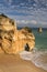 Admiring amazing stunning sea caves cliffs on sandy camilo beach in blue sky