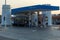 Adnoc Gas Station at sunset with traditional arab style pillars and modern blue station for gas and petrol fill up