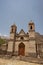 adobe church in an abandoned house, background texture image.Historic abandoned adobe wall cracked,dirty in ruins in a