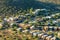 An adobe house neighborhood in the suburbs of Tuscon Arizona in the hills of the sonora desert with modern homes