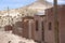 Adobe houses on Bolivian Altiplano with Andean mountain, Bolivia