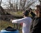 Adolescent boy shooting pistol with brass flying