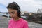 Adolescent Girl listening a song in pier, relaxed and smiling ready to training close to the sea. Young lady listen the radio with