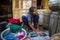 Adolescent in India washing clothes on the floor