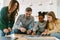 Adopted african little girl solving puzzles with family