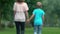 Adopted child and foster mother holding hands, going together in bright future