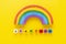 Adoption word colorful yelllow background rainbow.