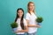 Adoptive family of adopted daugher child and woman mother smile holding pot plants, foster