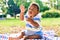 Adorable african american chubby toddler sitting on the grass at the park