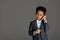 adorable african american kid talking by smartphone