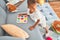 Adorable african american toddler learning maths using mathematics game around lots of toys at kindergarten