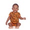 Adorable african baby with with brindle pajamas sitting on the f