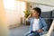 Adorable afro boy talking by phone while sitting on floor on