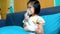 Adorable asian child holds a mask vapor inhaler for treatment of asthma