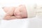 Adorable Asian newborn baby deeply sleeping smile Easter costume hat, tiny infant boy soft skin healthy sleep dream on white