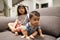 Adorable asian siblings being playful at their home stock photo