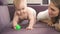 Adorable baby crawl on violet bed. child in diapers gnawing toy