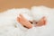 Adorable baby feet wrapped in a white blanket, tiny barefeet in a selective focus