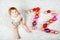 Adorable baby girl holding colorful vintage xmas toy ball in cute hands. Little child and Christmas tree balls as twelve